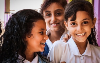 Children laughing together at a school in Yemen.