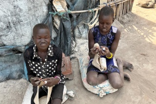 two girls kneeling on the ground