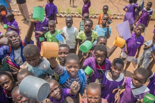 Group of children cheering with mugs
