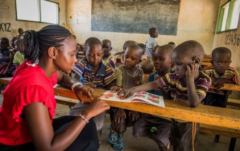 children in class listening attentively to their teacher