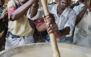 Volunteers stirring porridge