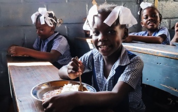 Girls eating Mary's Meals in Haiti