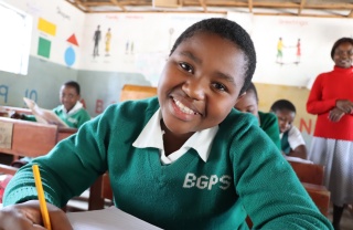 young girl in class smiling for the camera