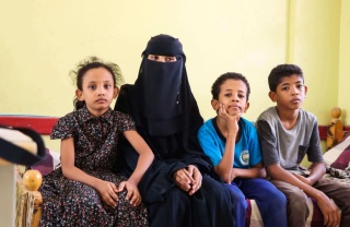 woman sitting with her children