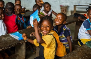Children laughing together in a classroom in Liberia