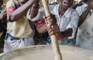 Volunteers stirring porridge