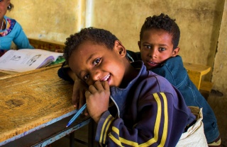 a child rest at his desk in school