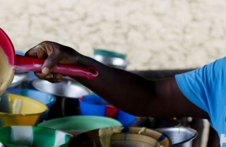 Volunteer serving porridge