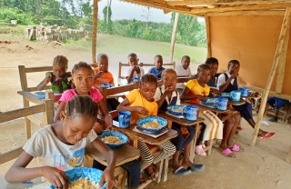 Children eating Mary's Meals in school in Liberia
