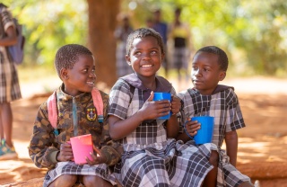 Children smiling with mugs 