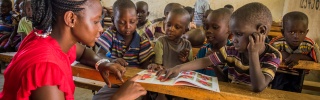 children in class listening attentively to their teacher