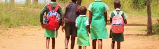 group of children walking away into the distance