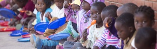 Children eating Mary's Meals at their school in Malawi