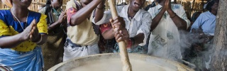 Volunteers stirring porridge