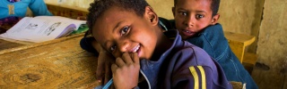 a child rest at his desk in school