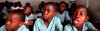 Children sit together in school