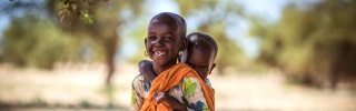 A child carries his sibling