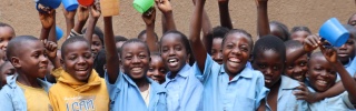 Children smiling with mugs 