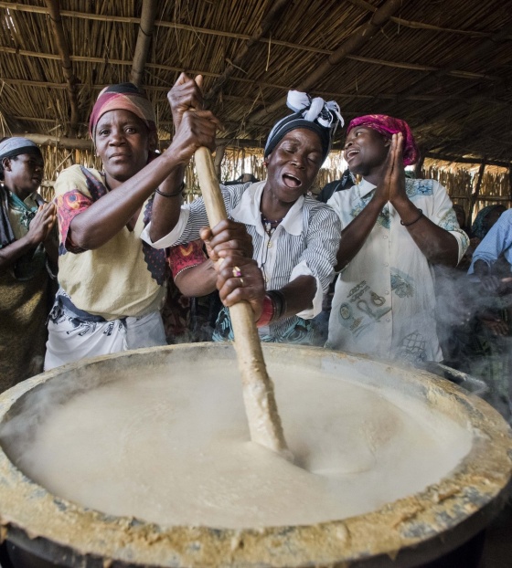 Mary's Meals volunteer cooks from Malawi preparing porridge to serve to school children. 
