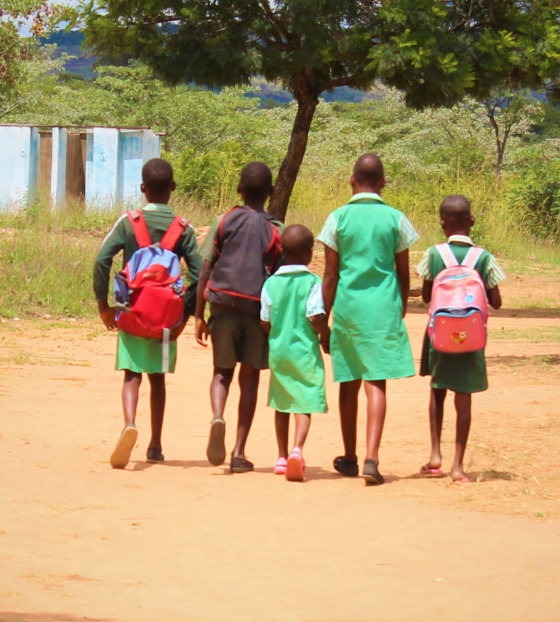 group of children walking away into the distance