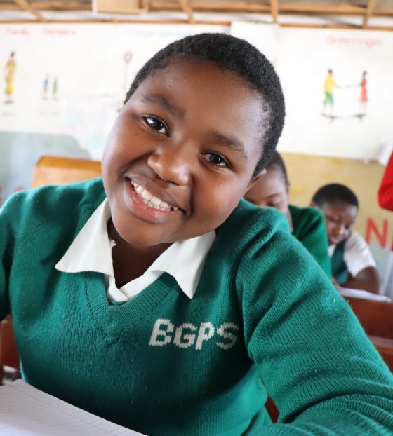 young girl in class smiling for the camera