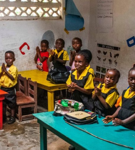 A classroom of children enjoying a lesson being taught by their teacher in a school in Liberia. 