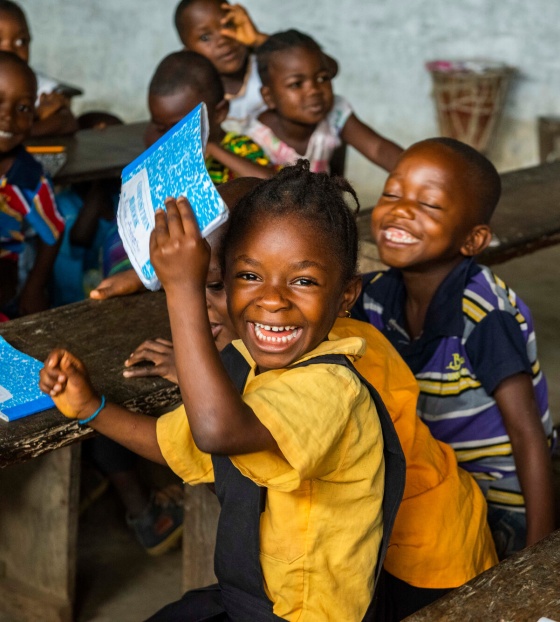 Children laughing together in a classroom in Liberia