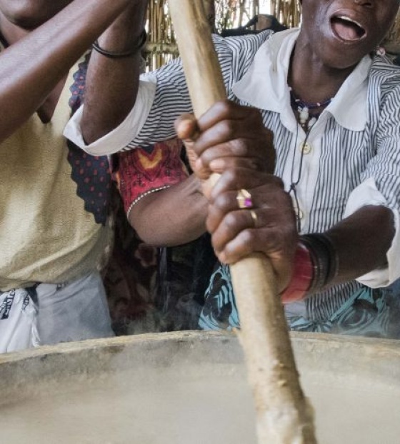 Volunteers stirring porridge