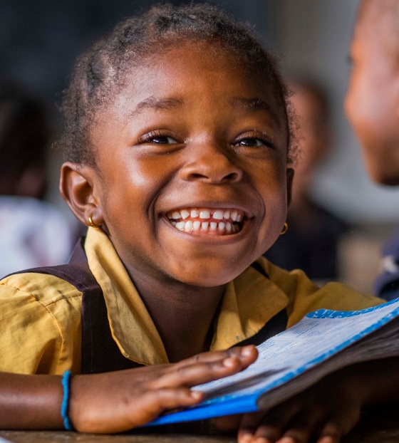 a smiling girl in class in liberia