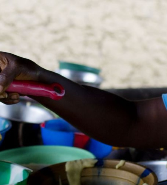 Volunteer serving porridge