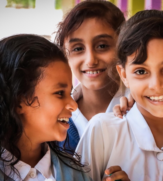 Children laughing together at a school in Yemen.