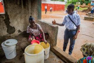 Momo, a school pupil from Liberia being served Mary's Meals in his place of education.