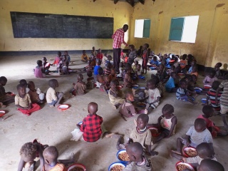 Children eating Mary's Meals together at school in Turkana, Kenya.