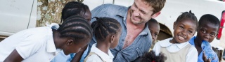 Gerard Butler with children in Haiti