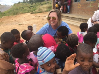 Regional Coordinator Michelle Keller with a group of children