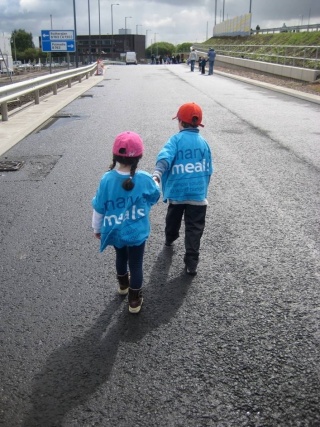Two children walking in Mary's Meals shirts