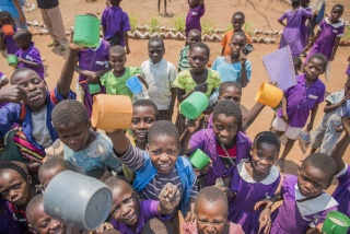 Group of children cheering with mugs