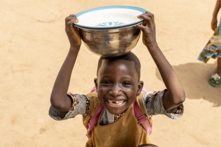 a child holds a bowl