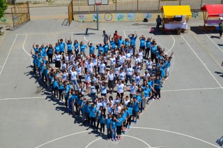 Volunteers standing in a heart shape