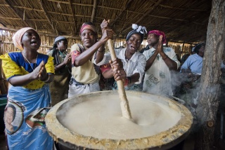 Volunteer stirring porridge