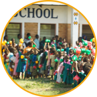 Children gather together outside school