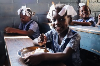 Girls eating Mary's Meals in Haiti