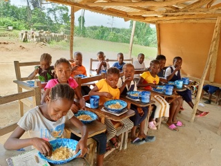 Children eating Mary's Meals in school in Liberia
